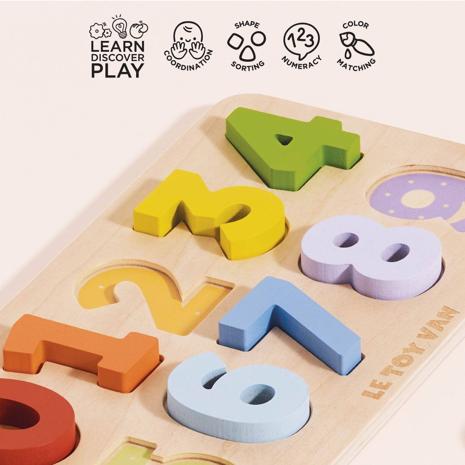 Colorful wooden puzzle with letters and numbers on a light background